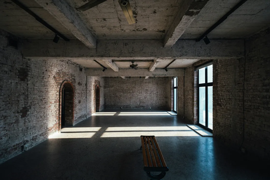 The DATUM studio — daylight through tall windows over a working floor.