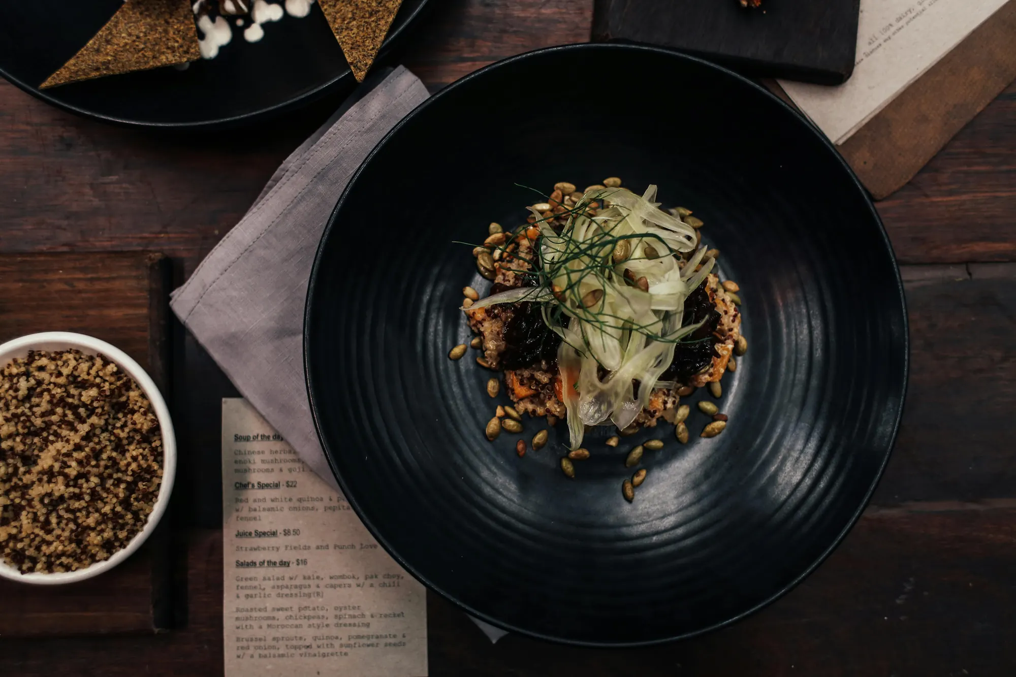 A plated dish lit by candlelight against darkness