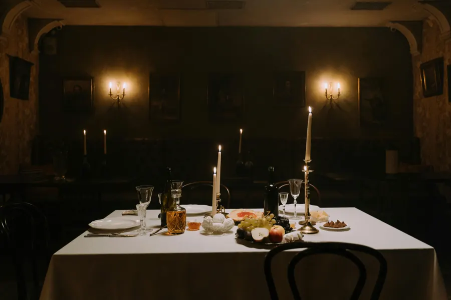 A dimly lit corner table with candles