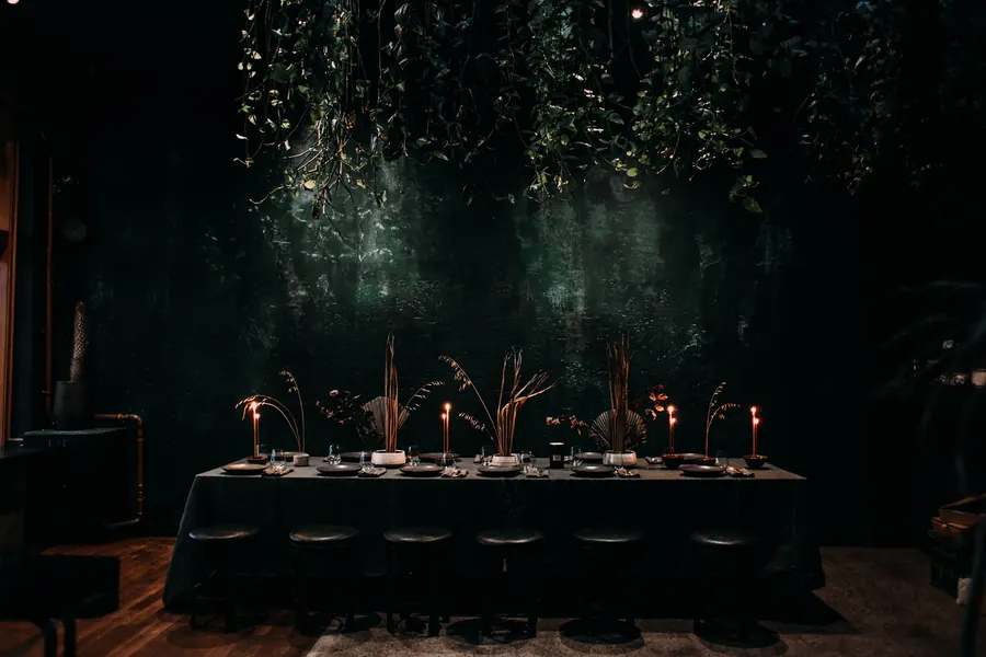 The long banquet table set for an evening service
