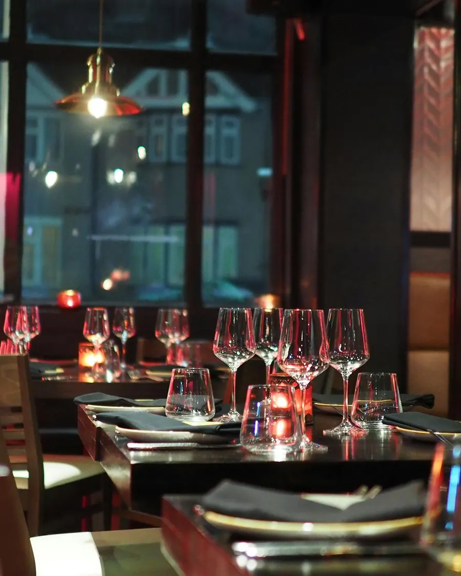 The bar at NOCTURNE, lit at dusk