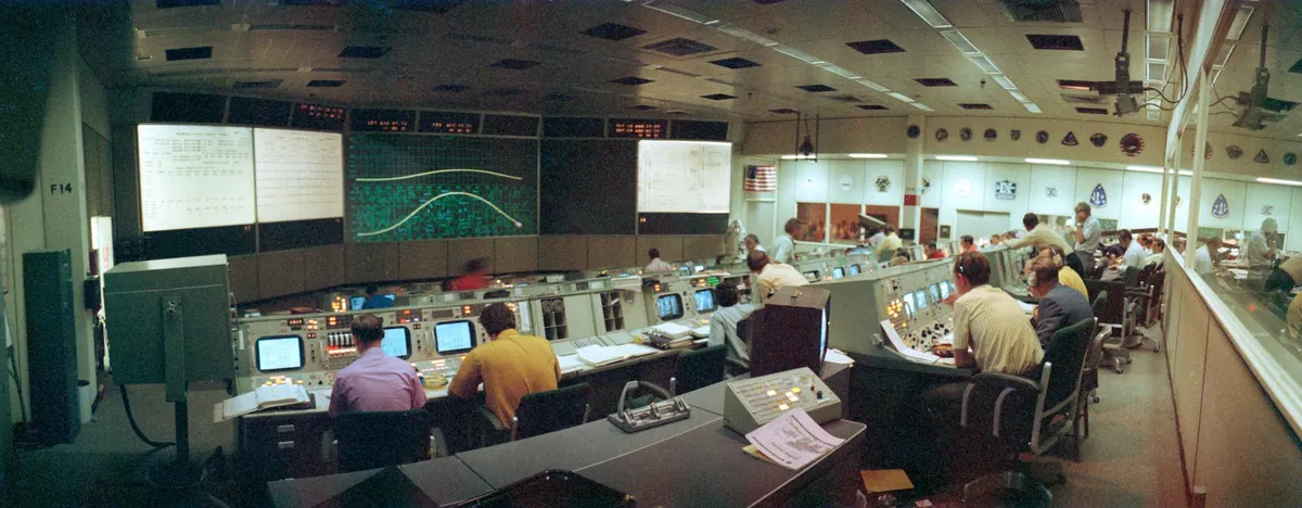 Founders and early flight directors at a console during an APSIS launch rehearsal.