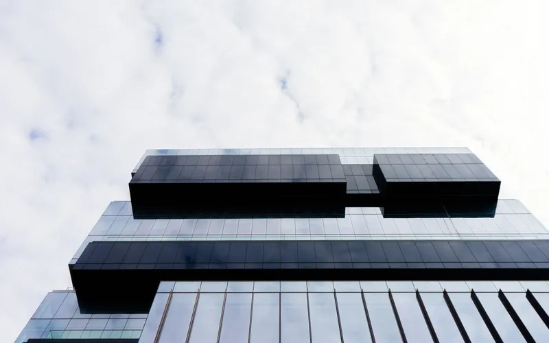 Glass-and-steel office tower seen from street level
