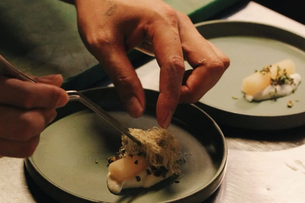 Chef Édouard finishing a course during service