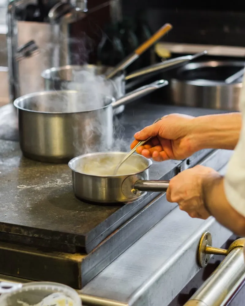 Chef finishing a sauce in the Bella Vista kitchen